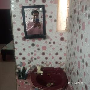 a person taking a picture of a bathroom with a toilet at Dwarka Home Stay 2 Only family in Dwarka