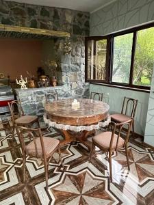 a dining room with a wooden table and chairs at Sivil&Sed in Hartʼagyugh