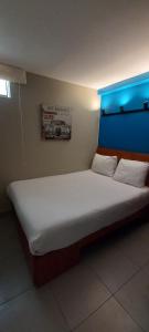 Cama ou camas em um quarto em Hotel Residencial Alfa