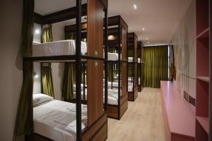 a row of bunk beds in a room at Corner Hostel in Shkodër