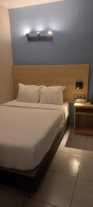 Cama ou camas em um quarto em Hotel Residencial Alfa