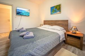 a bedroom with a large bed with towels on it at Koky in Juršići +46 photos