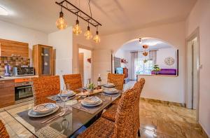 a kitchen and dining room with a table and chairs at Koky in Juršići