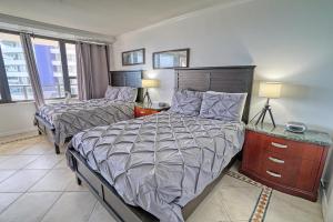 a bedroom with two beds and two lamps and windows at Oceanview Apartment on the beach 123 in Miami Beach