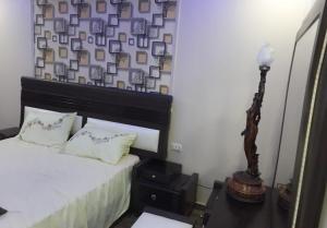 a bedroom with a bed and a lamp on a table at Jordan road Guest House in Madaba