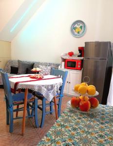 a kitchen with a table and chairs with fruit on the table at A Trecastagni - Etna Home in Trecastagni