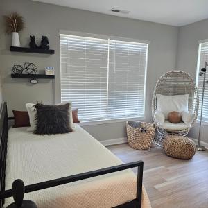 a bedroom with a bed and a chair and a window at Atlantic City Bungalow Retreat in Atlantic City