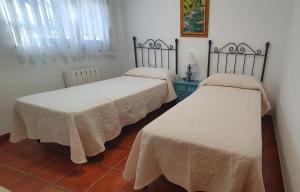 2 camas con sábanas blancas en una habitación en Casa San Francisco de Asís, en Córdoba