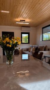 a living room with a vase of flowers on a table at Sielskie Chatki in Sandomierz