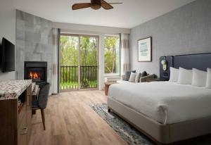 a bedroom with a bed and a fireplace at El Colibri Hotel & Spa in Cambria