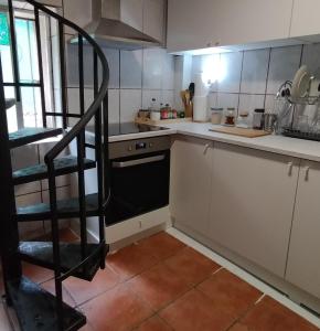 a kitchen with a spiral staircase in a kitchen at Casa Chato Casita San Roque in Alicante