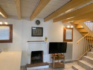 a living room with a tv and a fireplace at Pirinas Meteora in Kalabaka