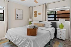 a bedroom with a bed with a basket on it at Lunar Beach Bungalow in Cocoa Beach