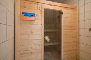 a shower with a glass door in a bathroom at U Gienka Pod Lasem in Święta Katarzyna