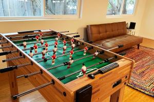 a large pool table with people in a living room at Large house and yard close to La Jolla, UCSD, UTC Mall! in San Diego