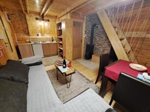a living room with a couch and a table at Vikendica Šumski Dragulj in Bajina Bašta