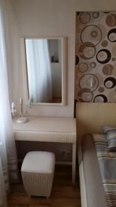 a bathroom with a sink and a mirror next to a bed at Veles Apartment in Prague