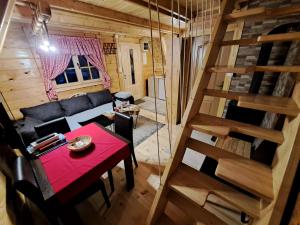 an overhead view of a living room with a table and a staircase at Vikendica Šumski Dragulj in Bajina Bašta