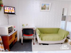 a living room with a couch and a tv at Ikebukuro 706 in Tokyo
