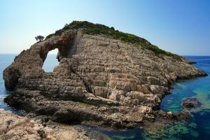 an island with an arch in the water at Villa Roxa Montuoso in Agios Leon