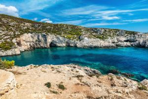a cove on the shore of a rocky island at Villa Roxa Montuoso in Agios Leon