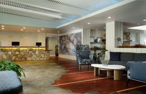 a lobby with furniture and a stone wall at Inn at Morro Bay in Morro Bay