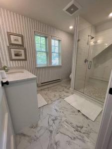 a bathroom with a shower and a sink at Upstairs at the Lake in Petoskey