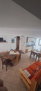 a room with a table and chairs and a kitchen at ALBERGO DIFFUSO ORNICA NEL CUORE in Ornica