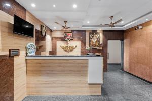 a lobby with a bar with a flat screen tv at VEERA RESIDENCY in Tiruvallūr