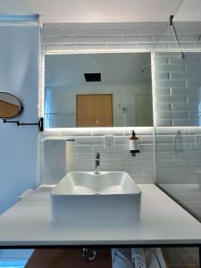 a bathroom with a white sink and a mirror at Olson Hotel Real Acueducto in Guadalajara +135 photos