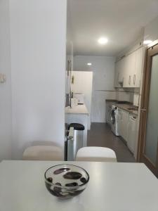 a kitchen with a table with a bowl on top of it at Piso con plaza de garaje y jardín in Cangas de Onís