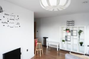 a living room with white walls and a chandelier at Inviting 2-Bed Apartment in Sheffield in Sheffield