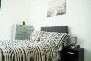 a bedroom with a bed with a pillow and a dresser at Inviting 2-Bed Apartment in Sheffield in Sheffield