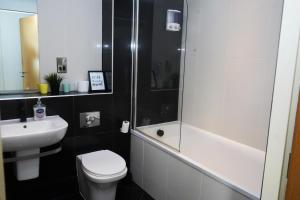 a bathroom with a shower and a toilet and a sink at Inviting 2-Bed Apartment in Sheffield in Sheffield