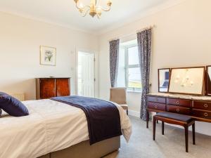 um quarto com uma cama, uma cómoda e um espelho em 4 Bed in St Keverne TVALL em Saint Keverne
