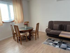 a living room with a table and chairs and a couch at Cheap house near the center of the city in Mostar