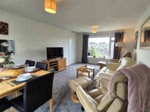 a living room with a couch and a table at 2 Bed in Ilfracombe 82615 in Ilfracombe