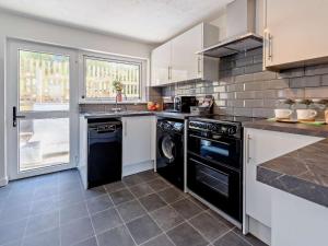 a kitchen with a washer and dryer at 2 Bed in Ilfracombe 82615 in Ilfracombe