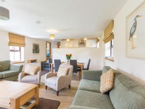 a living room with a couch and chairs and a table at 1 Bed in Cairnbaan CA304 in Lochgilphead