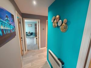 a room with a blue wall with shells on it at 2br Stunning City Centre Apt in Belfast