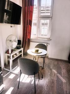 グダニスクにあるCloud 9 - wyjątkowa majówkaのテーブルと椅子、窓が備わる客室です。
