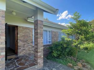 a house with a brick pillar and a door at Graceful Getaway in Grahamstown