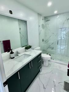 a bathroom with a sink and a shower and a toilet at Private Luxury Full Home in Markham in Markham