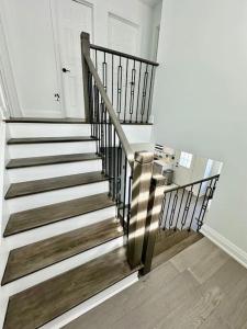 a spiral staircase in a room with a door at Private Luxury Full Home in Markham in Markham