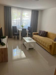 a living room with a couch and a table at Apartman Mijailović 4 in Soko Banja