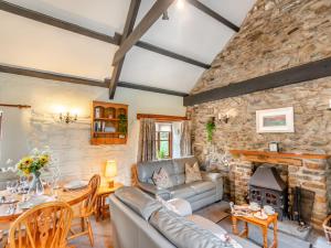 a living room with a couch and a fireplace at 2 Bed in Trefin 94123 in Trevine