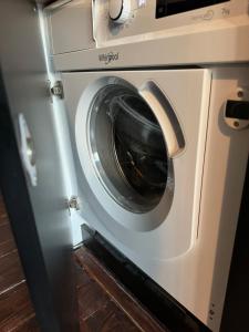 uma máquina de lavar roupa com a porta aberta numa cozinha em Apartament Sopoth em Sopot