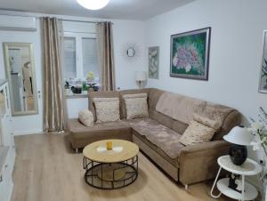 a living room with a couch and a table at Apartment in Zadar in Zadar