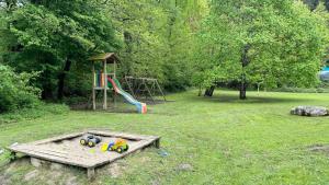 a park with a playground with a slide and a playintend at Apartment am Ossiachersee mit eigenem Seezugang in Landskron