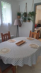 a dining room table with a black and white table cloth at Appartement La Garance, Gites de Daumesnil in Morlaix